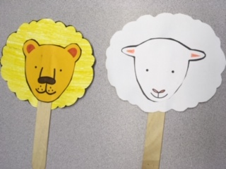 two-sided yellow lion and white lamb stick puppet
