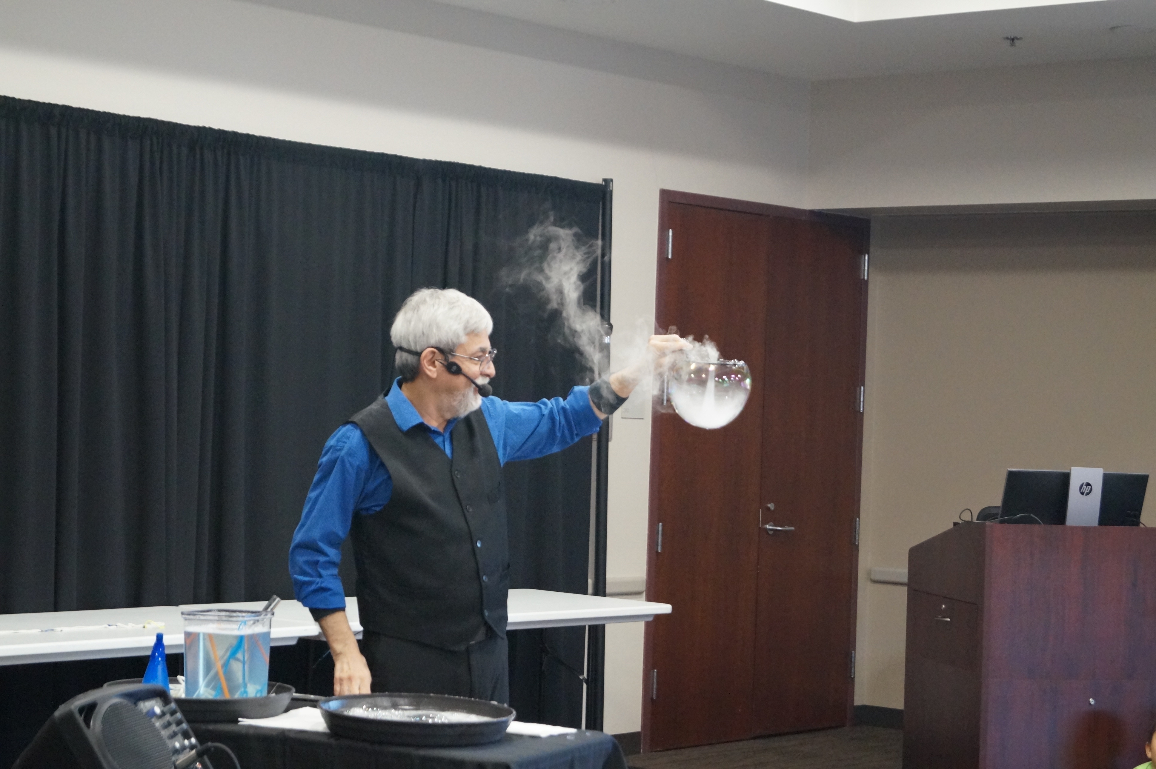 Performer Ben Jimenez holding a bubble filled with smoke