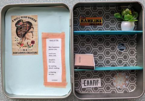 Sample mini bookcase made from a rectangular hinged tin. On the left: light blue paper backround with "a well-read woman is a dangerous creature" poster and a poem, "Salute" by A.R. Ammons. On the right: gray geometric paper backround, two teal shelves made from popsicle sticks. Top shelf: "Visit Hawkins Indiana" sticker and fake potted plant. Middle shelf: mini notebook made from folded paper and The Strokes sticker. Bottom shelf: CAAMP sticker and teal and gold paper mandala.