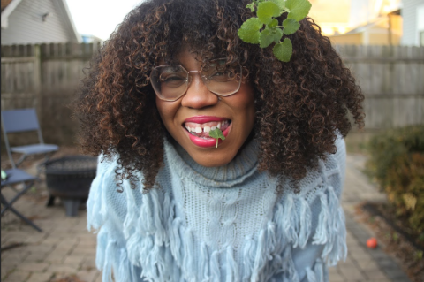 Pictured Alexis Nikole with a small plant in her mouth